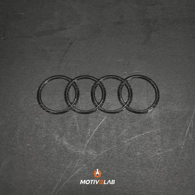Audi carbon fibre badge featuring the Audi logo